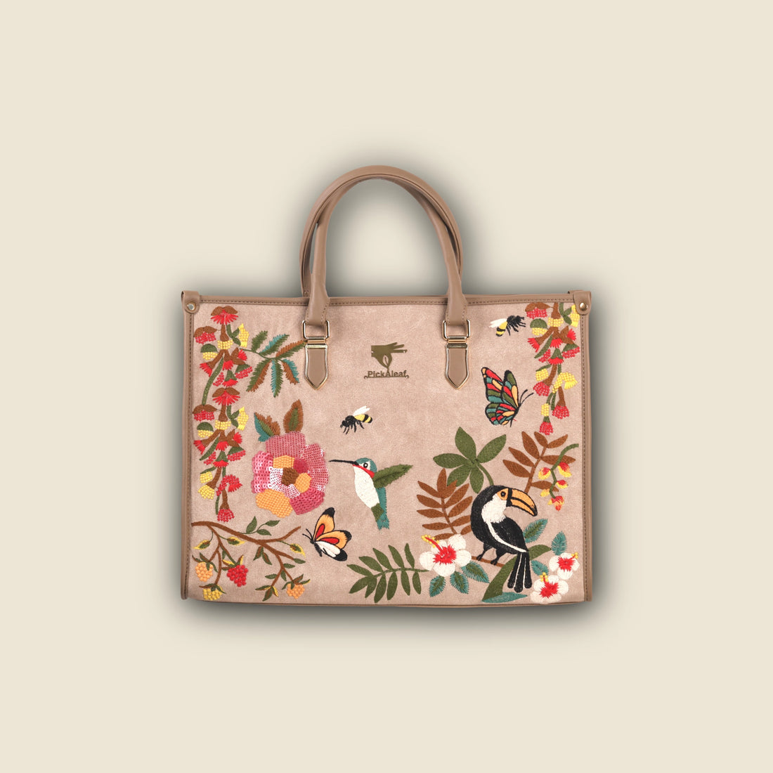 Woman holding a floral and bird-patterned handbag against a green background